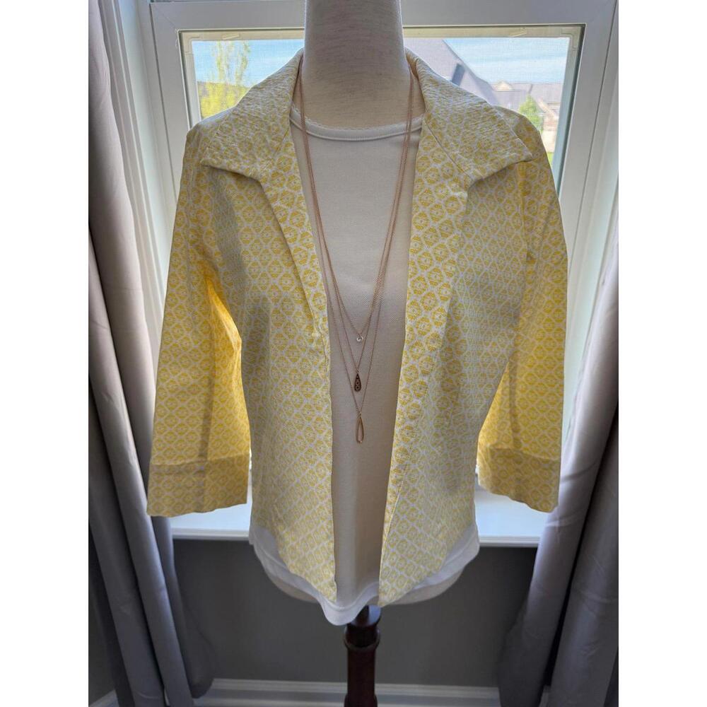 Patterned jacket, white top and necklace